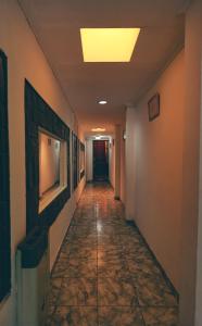 a hallway in an office building with a light on the ceiling at Hosteria Pia Guapi in Colón