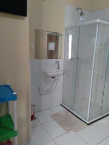 a bathroom with a shower and a sink at Canto do Casarão in Santos