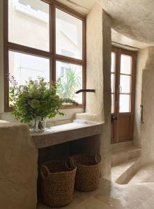 a bathroom with a window and two baskets on the floor at La Place B&B in Sancerre