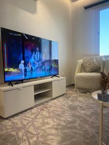 a living room with a large flat screen tv at اطلالة الريان شقة خاصة in Jeddah +24 photos