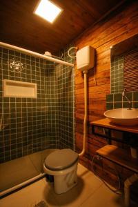 a bathroom with a toilet and a sink at Casa na Vila de Abraão in Abraão +32 photos