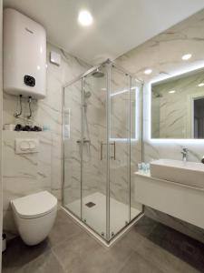 a bathroom with a shower and a toilet and a sink at Apartment Lantana Hvar in Hvar +34 photos