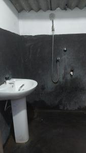 a bathroom with a sink and a shower at House near main temple in Batticaloa