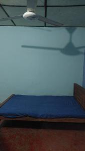 a bedroom with a blue bed in a room at House near main temple in Batticaloa