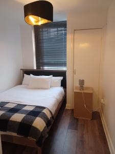 Katil atau katil-katil dalam bilik di Q Flat Skyview Central Bradford