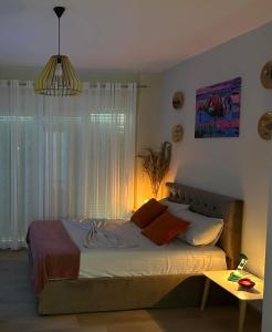 a bedroom with a large bed with a window at Sea La Vie in Shëngjin