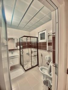 a bathroom with a shower and a toilet at Konak Grand Apart in Uzungol