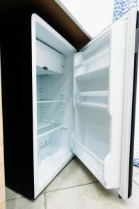 an empty refrigerator with its door open at Palazzo Boemondo in Bari