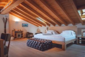 um quarto com uma cama grande e um tecto de madeira em Agriturismo La Pertica em Costermano