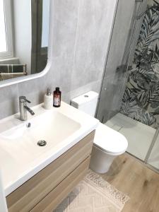 a bathroom with a sink and a toilet and a mirror at Casa verde in Ventimiglia