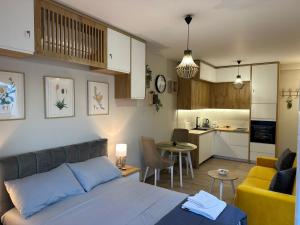 a living room with a bed and a kitchen at Sea La Vie in Shëngjin