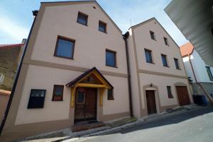 a two story building with a door on a street at Penzionu Aurelius u Bednářů in Pavlov