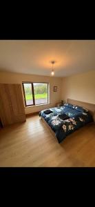 a bedroom with a bed and a large window at Beautiful Home in Dingle in Dingle