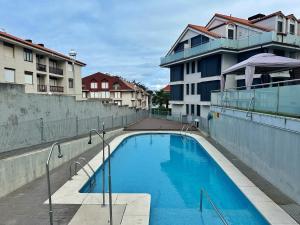 a swimming pool on the side of a building at El Patuco - 6821 in Noja