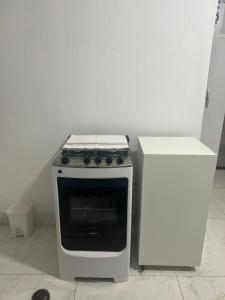 a stove sitting in a kitchen next to a counter at Casa 400m do shopping in Governador Valadares