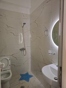 a bathroom with a toilet and a sink at DEA Room 1 in Sarandë