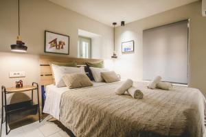 a bedroom with a large bed with two pillows on it at MASTER ROSE STUDIO in old town in Nafplio
