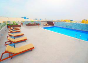 a swimming pool on the roof of a building at The Grand Lux Hotel in Doha