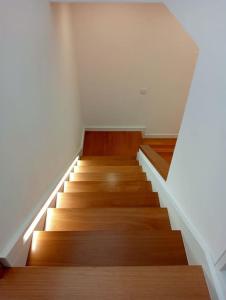 a staircase in a building with wooden floors and ceilings at Villa Amendoa in Arco da Calheta