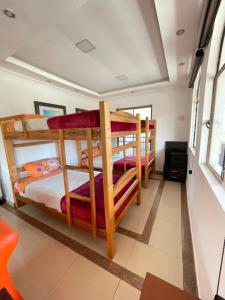 a bedroom with two bunk beds in a room at Hacienda Le Plus in Quito