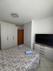 a bedroom with a bed and a flat screen tv at Consumella24 in Portoferraio