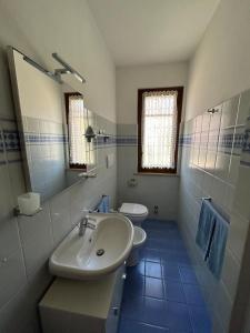 a bathroom with a sink and a toilet and a mirror at Consumella24 in Portoferraio