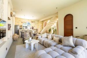 un soggiorno con divano e tavolo di Amani Villas: New, Luxury, Mediterranean, Private Pool, Canggu a Canggu