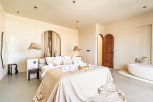 a bedroom with a bed and a bath tub at Amani Villas: New, Luxury, Mediterranean, Private Pool, Canggu in Canggu +35 photos