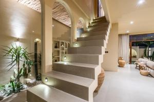 a staircase in a house with a living room at Amani Villas: New, Luxury, Mediterranean, Private Pool, Canggu in Canggu