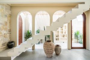 a white staircase in a room with vases at Amani Villas: New, Luxury, Mediterranean, Private Pool, Canggu in Canggu
