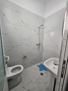 a bathroom with a toilet and a sink at DEA Room 2 in Sarandë