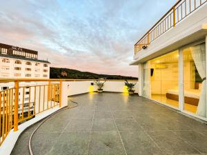 a balcony with a view of a building at Sailing Hotel Phú Quốc in Phu Quoc