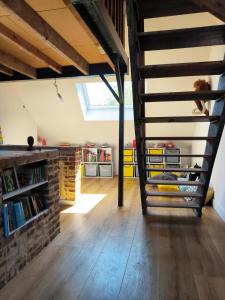 a room with a loft with a staircase and a book shelf at Villa The Treport - terrasses & vue mer in Le Tréport