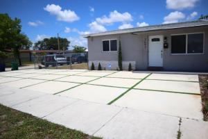 a concrete driveway in front of a house at The place to Be in Miami Gardens