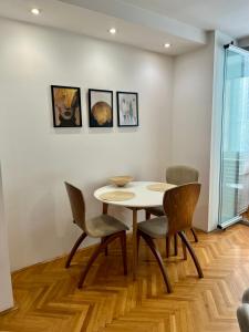 a dining room with a table and chairs at Luxury Getaway Apartment in Skopje