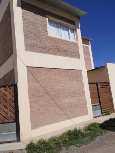 a brick retaining wall on a house at Depto Civora 1 in Villa Regina