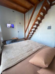 een bed met een kussen in een kamer met een trap bij Resy home syariah family room dekat alun2 wonosobo in Kalianget