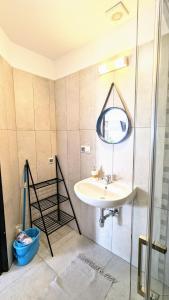 a bathroom with a sink and a mirror at ISLAND4U in Gdańsk