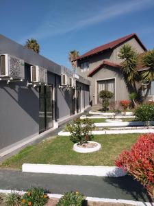 a building with a yard with plants and flowers at Alimop Bed and Breakfast in Midrand