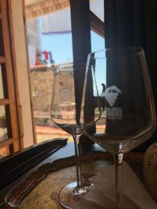 two wine glasses sitting on a table next to a window at La Corinna in Lerici +5 photos
