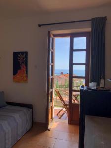 a bedroom with a door open to a balcony at La Corinna in Lerici