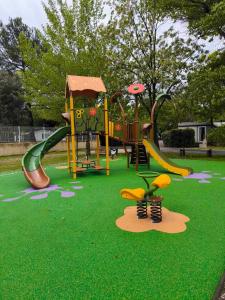 a park with a playground with a slide at Camping Domaine des Iscles in La Roque-dʼAnthéron +17 photos