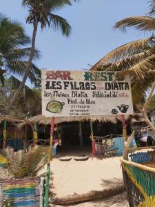 a store on the beach with a palm tree at Chez Jacques Diatta in Cap Skirring