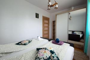 - une chambre avec 2 lits et un miroir dans l'établissement Duże mieszkanie, ogród i parking, à Radwanice