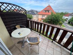 a balcony with a table and chairs and a table at Lucky Villa in Hévíz