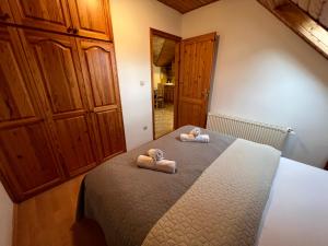 a bedroom with a bed with two towels on it at Lucky Villa in Hévíz