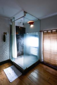 a glass shower in a room with a window at Samsara Apartments by Baber Mahal Revisited in Kathmandu
