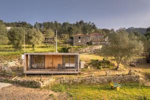 a small house on top of a hill at O Refugio Nas Vinhas in Badim