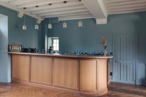 a bar in a room with a blue wall at Château De Razay in Céré-la-Ronde