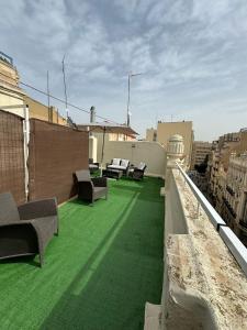 un patio en la azotea con suelo verde en un edificio en Estudio triple con terraza y vistas en el centro en Albacete